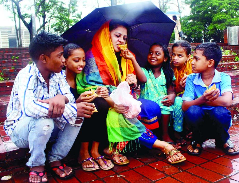 A woman named Sister Helen who is trying to rehabilitate street children spends a happy moment with the urchins at Chandrima Udyan in the city on Friday.