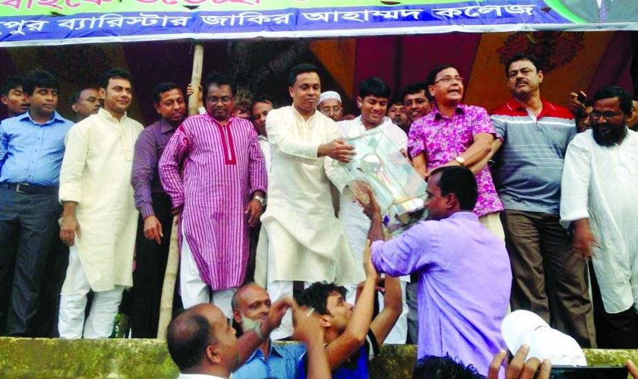 Barrister Zakir Ahammad handing over the championship trophy to Ichchapura Football XI, the champions of the Gold Cup of Tk one lakh. Ichchapura Football XI beat Barikhana Football XI in the final at the Laur Fatehpur Ground in B'Baria on Friday.