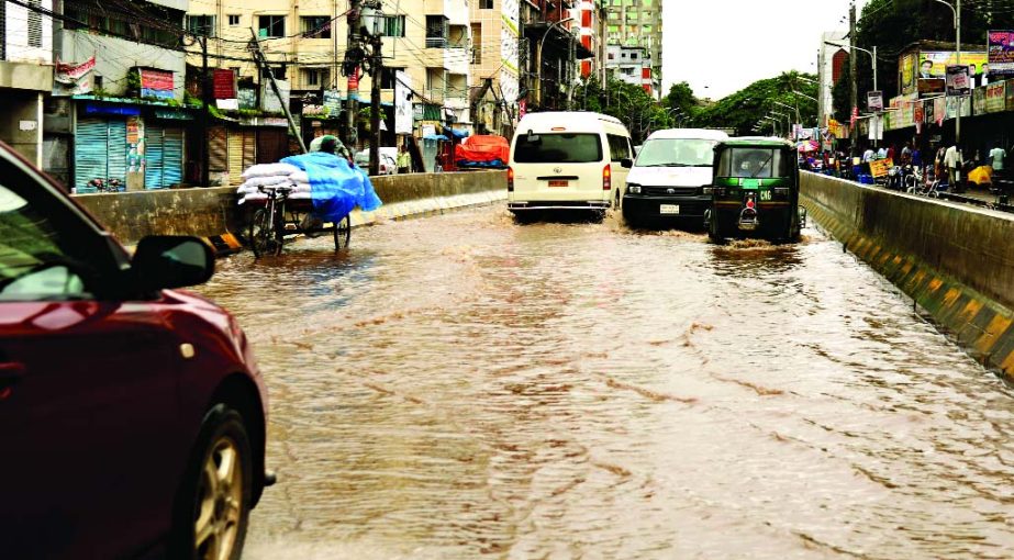 An approach portion of the Mayor Hanif Flyover goes under rain water. The vehicles are seen struggling to escape the water-logged on flyover. This photo was taken from Chandkhar Pool area on Friday.