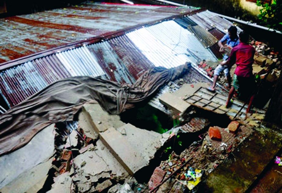 A tin-shed house was severely damaged when the wall of an adjacent building collapsed on it when cyclonic storm 'Komen' swept over the locality at Nandan Kanon in Chittagong on Friday early morning.