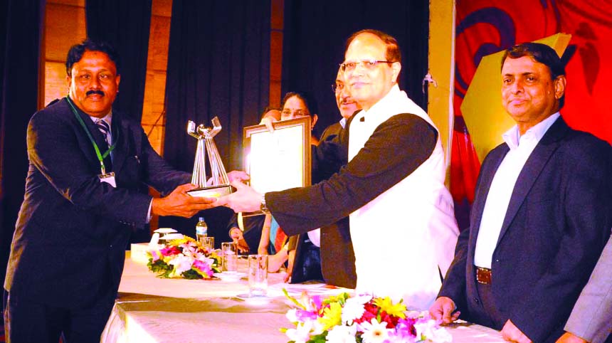 Md Jakir Hossain, receiving 'Bangladesh Bank Remittance Award-2014' from BB Governor Dr Atiur Rahman as the highest remittance sender from Kuwait at the BB training institute in the city on Saturday.