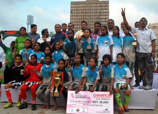 Mymensingh District team, the champions of the JFA Under-14 Women's National Football Championship with the guests and the officials pose for a photo session at the Bangabandhu National Stadium on Sunday.