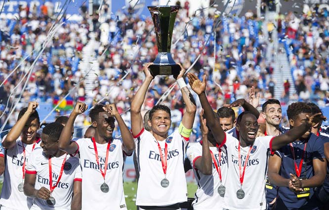 Paris Saint-Germain captain Thiago Silva (center) along with teammates raise the Trophy of Champions after defeating Olympique Lyonnais in Montreal on Saturday.