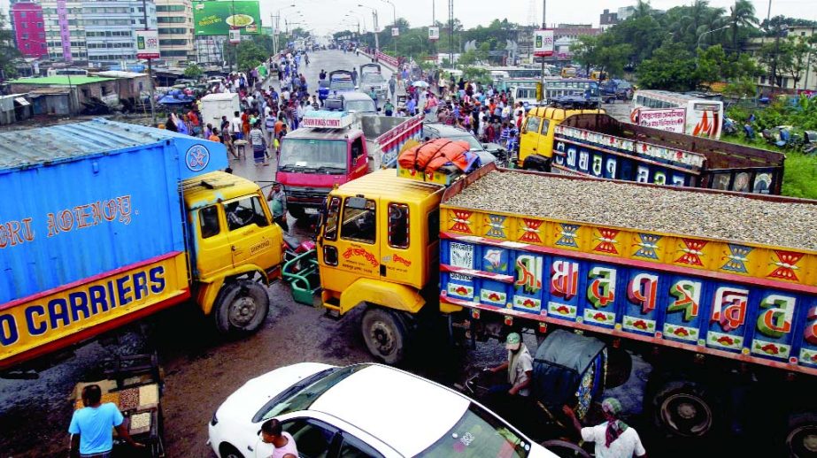 Vehicles including goods-laden trucks and covered vans were haphazardly parked on the approach road of Buriganga Bridge-I blocking from different directions on Sunday as mark of protest against raising toll rates.