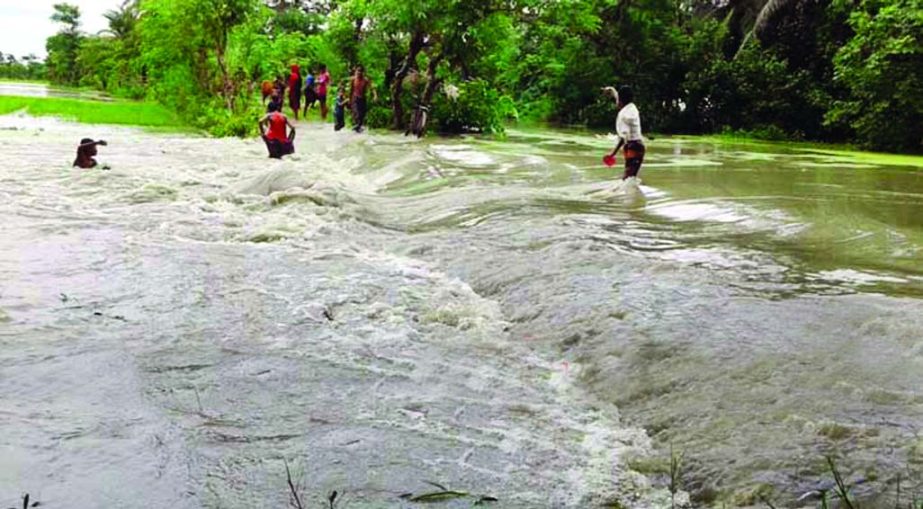 Due to strong current of the flood waters and tidal surge flood protection embankment was broken at several points devouring many villages at Companiganj in Noakhali. This snap was taken on Sunday.