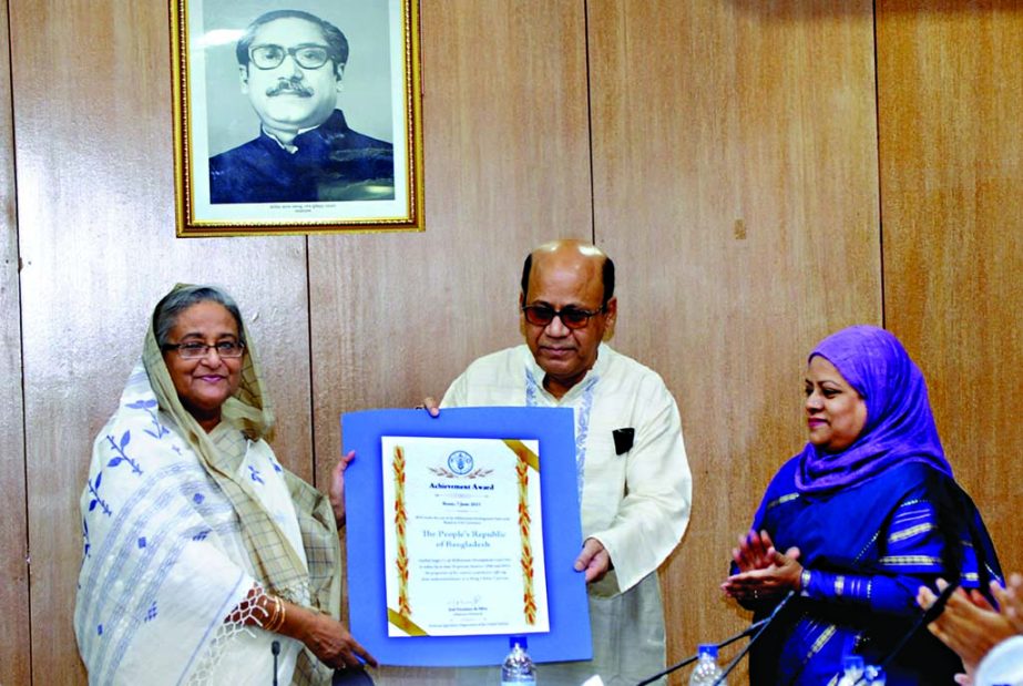 Food Minister Advocate Qumrul Islam formally handing over the FAO 'Achievement Award' to Prime Minister Sheikh Hasina at the cabinet meeting held at Bangladesh Secretariat on Monday. BSS photo