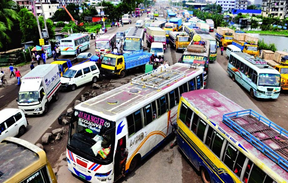 Vehicles including inter-district buses were stuck on several highways following the movement against banning of auto-rickshaws for the 3rd consecutive day on Monday. This photo was taken from Shanir Akhra area.