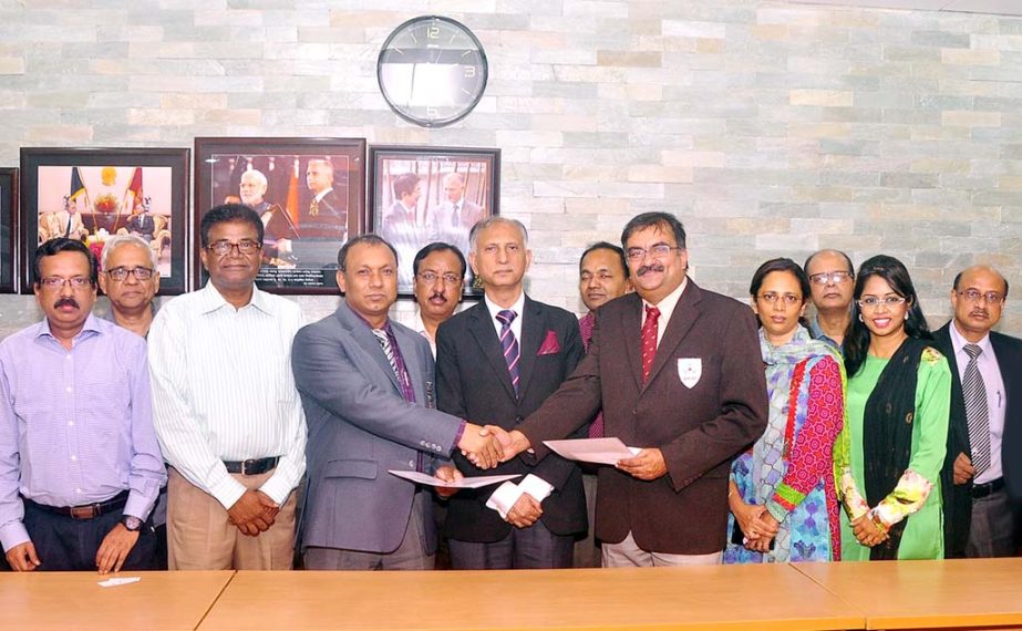 Treasurer of Dhaka University Prof Dr Md. Kamal Uddin and Dean of the Faculty of Medicine of AIMST University Prof Dr PK Rajesh exchanging MoU documents signed on Tuesday while Vice-Chancellor of DU Prof Dr AAMS Arefin Siddique was present on the occasion