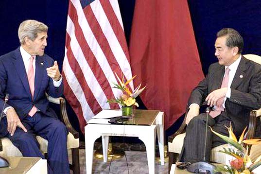 US Secretary of State John Kerry (L) and China's Foreign Minister Wang Yi talk before a bilateral meeting at the Putra World Trade Centre on Wednesday in Kuala Lumpur.