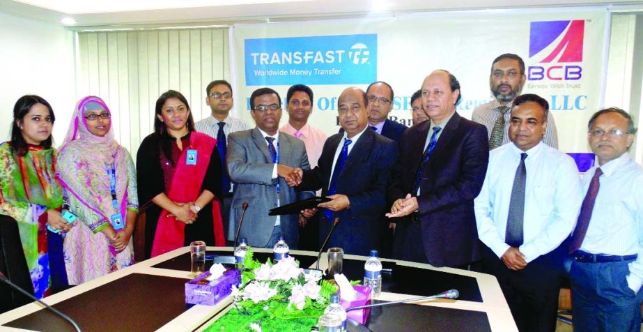 Mohammad Khairuzzaman, Country Manager of Transfast Remittance LLC, Bangladesh and Abu Sadek Md Sohel, Managing Director of Bangladesh Commerce Bank sign an agreement for remittance service at its head office on Wednesday.