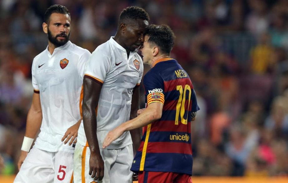 Barcelona's Lionel Messi (right) and Roma's Mapou Yanga-Mbiwa get involved in a scuffle during the Joan Gamper trophy soccer match between FC Barcelona and AS Roma at the Camp Nou stadium in Barcelona, Spain on Wednesday.