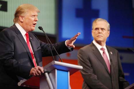Republican presidential candidate Donald Trump, left, speaks as Jeb Bush listens during the first Republican presidential debate at the Quicken Loans Arena on Thursday in Cleveland.