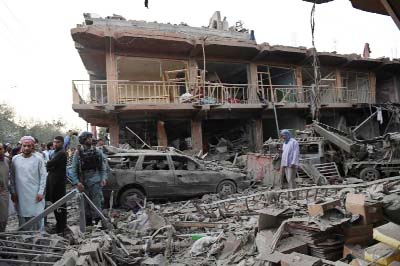 Residents walk through a market destroyed after a truck packed with explosives detonated near an army base in Kabul on Friday.