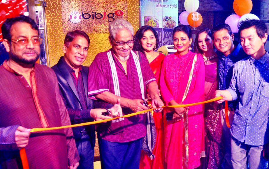 Poet Asad Chowdhury, inaugurating 'bibigo', a Korean fast-food and restaurant, by cutting ribbon at Goribe Newaj Avenue, Uttara in the city on Friday. Md Badsha Alamgir, Managing Director of the restaurant was present.