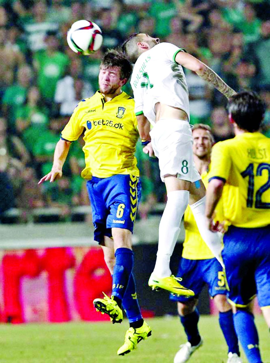 Omonia Nicosia's Roushias Onisiforos (right) jumps for the ball with Nielsen Martin of Brondly IF during a third qualifying round second leg soccer match between Omonia and Brondly IF at GSP stadium in Nicosia, Cyprus on Thursday.