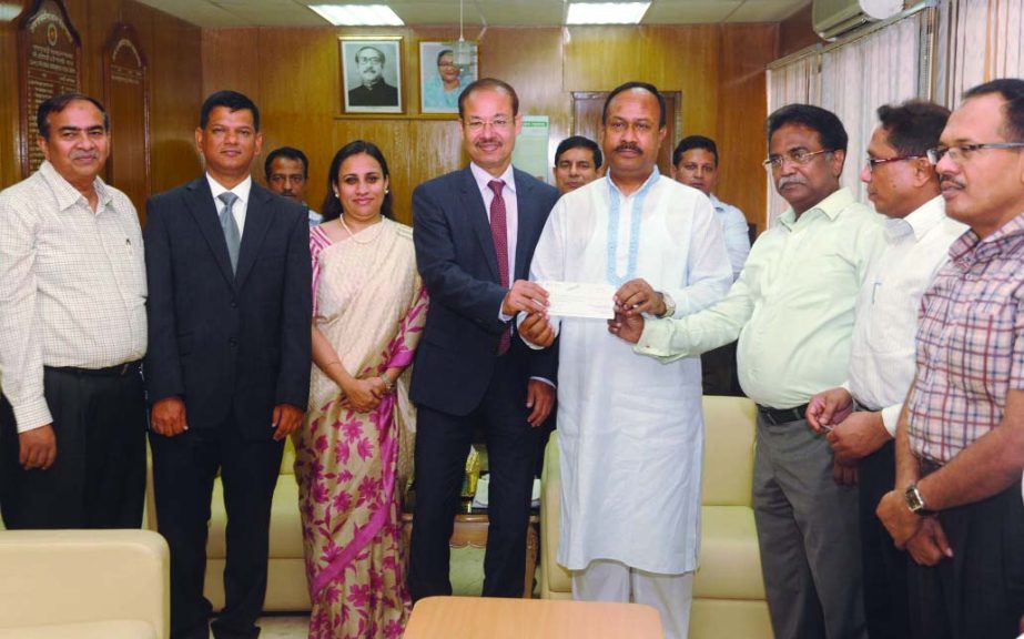 State Minister for Labour and Manpower Mujibul Haque (Chunnu), receiving a cheque from Masud Khan, Finance Director of Lafarge Surma Cement Limited for Bangladesh Workers' Welfare Foundation at the secretariat recently. Labour and Manpower Secretary Mika