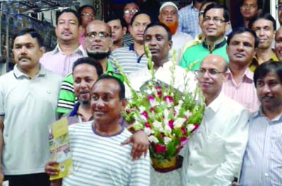 CHUNARUGHAT(Habiganj): Nazin Uddin Samsu, Mayor, Chunarughat Pourashava being greeted by '83 batch students of Habiganj Govt High School at a re-union programme on Wednesday. The cover of the magazine Sotirtho- 83 was unveiled there .