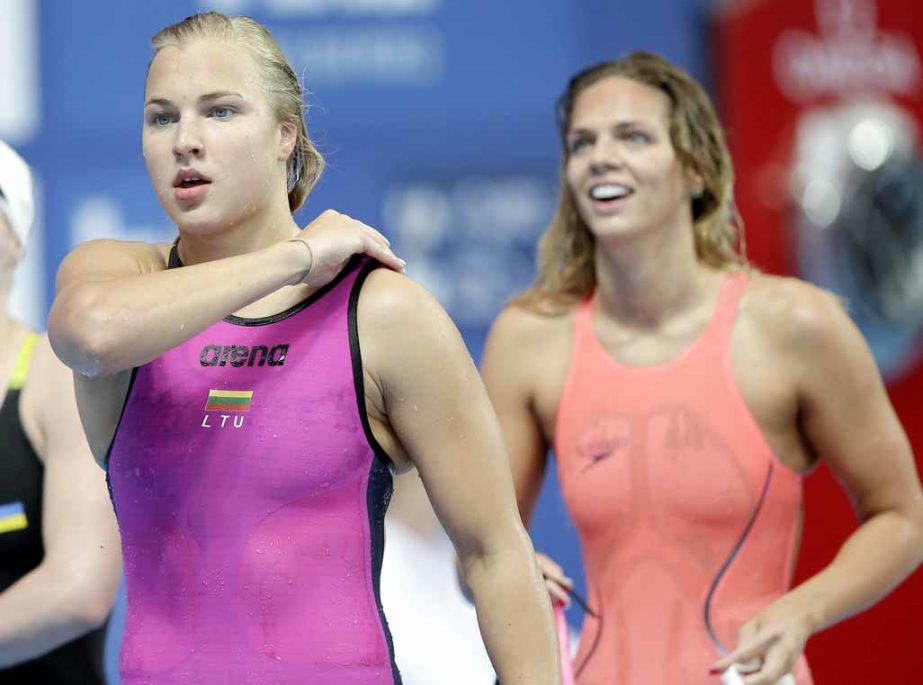 Russia's Yuliya Efimova (right) smiles as she and Lithuania's Ruta Meilutyte (left) walk beside the pool after a women's 50m breaststroke heat race at the Swimming World Championships in Kazan, Russia on Saturday.