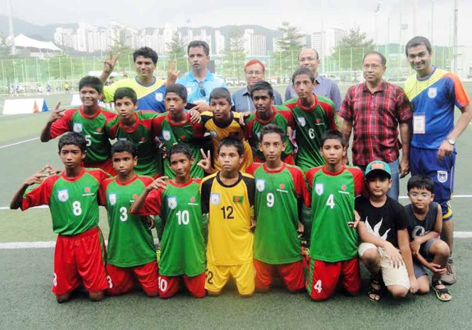 Bangladesh Under-12 National Football team and officials of Bangladesh Embassy pose for a photo session after beating Ansan Junior Under-12 team by a solitary goal in their match of the Asian Youth Under-12 Football Fiesta in South Korea on Saturday.