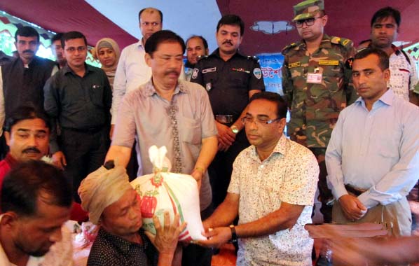 State Minister for CHT Affairs Bir Bahadur MP distributing relief goods among the flood victims at Ali Kadam in Bandarban recently.