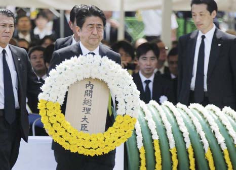 Japan's Prime Minister Shinzo Abe offers a flower wreath for the victims of the 1945 atomic bombing, during a ceremony commemorating the 70th anniversary of the bombing of the city at Nagasaki's Peace Park in western Japan on Sunday.