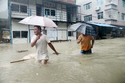 People wade through a flooded street at a town hit by Typhoon Soudelor in Ningde, Fujian province, China on Sunday.