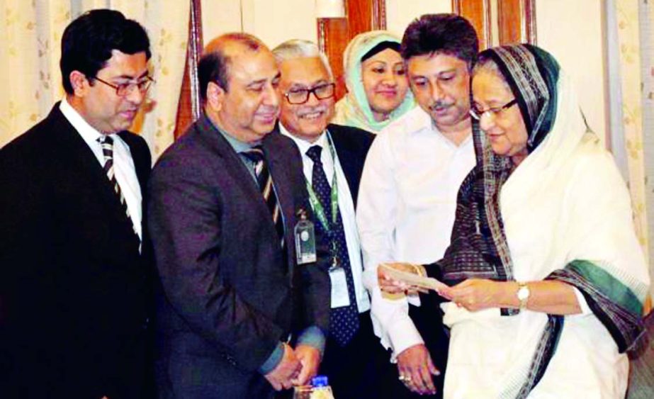 Prime Minister Sheikh Hasina, receiving a cheque of Tk1 one crore from Barrister Sheikh Fazle Noor Taposh, MP, Chairman, Executive Committee of Modhumoti Bank Limited for "Father of the Nation Bangabandhu Sheikh Mujibur Rahman Memorial Trust Fund" from