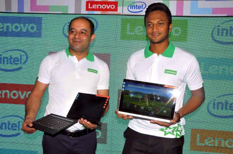 All-rounder Shakib Al Hasan (right) pose with a 'Lenova' laptop after he was formally named the brand ambassador of 'Lenova' at his restaurant Shakib's All-rounder Dining in the city on Sunday. ' Lenova' is a PC maker and IT company.