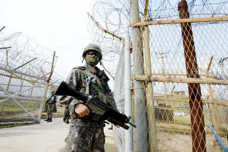 South Korean soldiers patrol along the scene of a blast inside the demilitarized zone separating the two Koreas in Paju, South Korea, in this picture taken on Sunday by the Defense Ministry and released by Yonhap on August 10, 2015. South Korea's militar