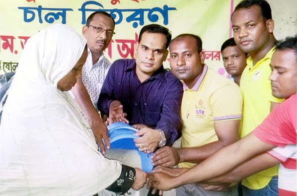 Councilor M Ashraful Alam distributing relief goods among the flood victims at Sholoshahar in the city recently.