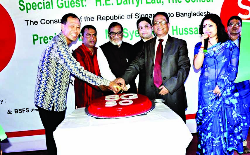 Liberation War Affairs Minister AKM Mozammel Huq along with other distinguished guests cutting cake on the occasion of the 50th National Day of Singapore at a function organised by Bangladesh-Singapore Friendship Society (BSFS)(proposed) and W & W Grains