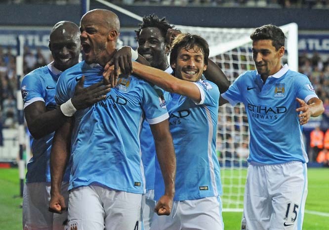 Manchester City's Vincent Kompany (2nd left) celebrates with teammates after scoring during the English Premier League soccer match between West Bromwich Albion and Manchester City at the Hawthorns, West Bromwich, England on Monday.