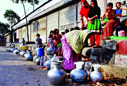 Due to acute water crisis the people of city's Hajaribagh area are seen in long queue to collect drinking water on Tuesday.