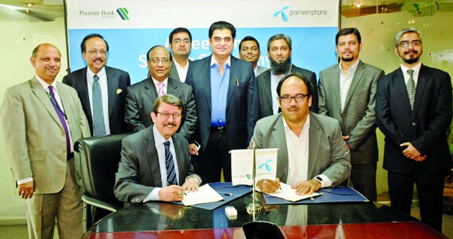 Dewan Anwarul Latif, DMD of The Premier Bank Limited and Sajjad Alam, Deputy Director of Direct Sales of Grameenphone Ltd, sign an agreement to provide complete communication facilities under its Business Solutions package at the bank's head office on We