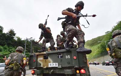 South Korean soldiers get off a truck during an anti-terror drill as part of an annual joint military drill called Ulchi Freedom, outside a tunnel in Seoul.