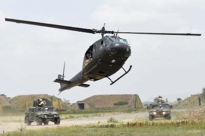 Georgian medevac helicopter flies above US marine Humvees during a multinational NATO military exercise "Agile Spirit 2015"" at the Vaziani military base outside Tbilisi."