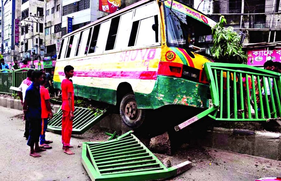 A passenger bus rammed over the road divider in city's Topkhana Road on Friday smashing the railings on the spot.