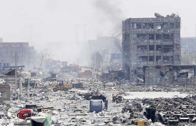 Buildings stand in ruins on Friday at the site of the explosions in Tianjin as residents are evacuated amid fears over toxic chemicals.