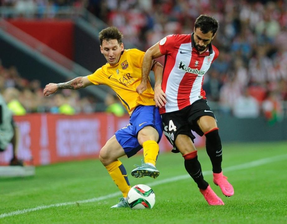 Barcelona's Argentinian forward Lionel Messi (L) vies with Athletic Bilbao's defender Mikel Balenziaga during the Spanish Supercup first-leg football match at the San Mames stadium in Bilbao on Friday.