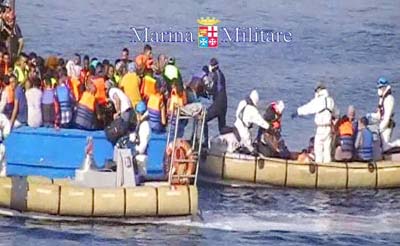 A Italian Navy rescuing migrants crowded onto a fishing boat off the coast of Libya.