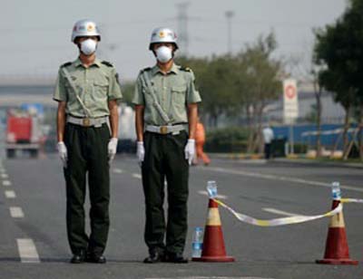 Two soldiers wearing face masks stand at a checkpoint in Tianjin.