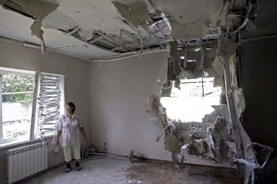 A local resident stands in a flat that, according to locals, was damaged by recent shelling, on the outskirts of Donetsk, Ukraineon Sunday.