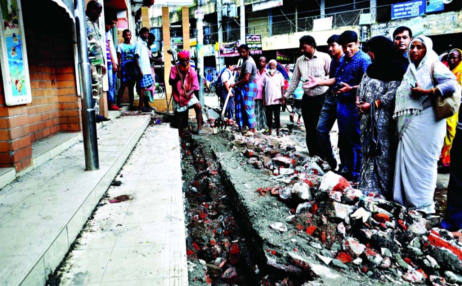 An illegally occupied drain covering with slabs by local influential being demolished in presence of Acting Mayor of DSCC Ayesha Mokarram in a bid to remove the water-logging. This photo was taken from Ward No 26 of Azimpur on Monday.