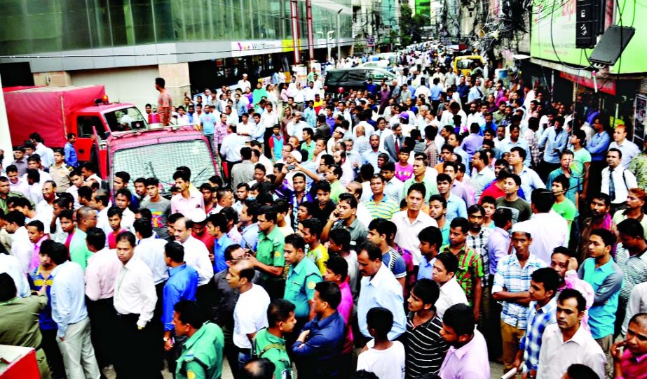 Panicked people crowding in the street as fire broke out at the Basement of Uttara Bank Head office at Motijheel on Monday. Fire fighters finally doused the flame.