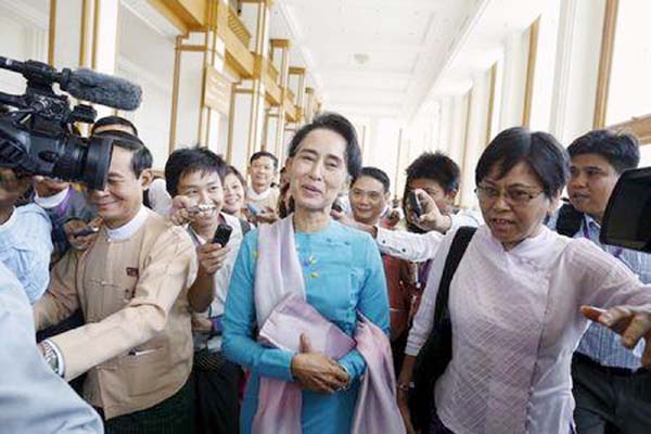 Myanmar pro-democracy and opposition leader Aung San Suu Kyi talks to the media as she attends a Parliament meeting at the Lower House of Parliament in Naypyitaw on Tuesday.