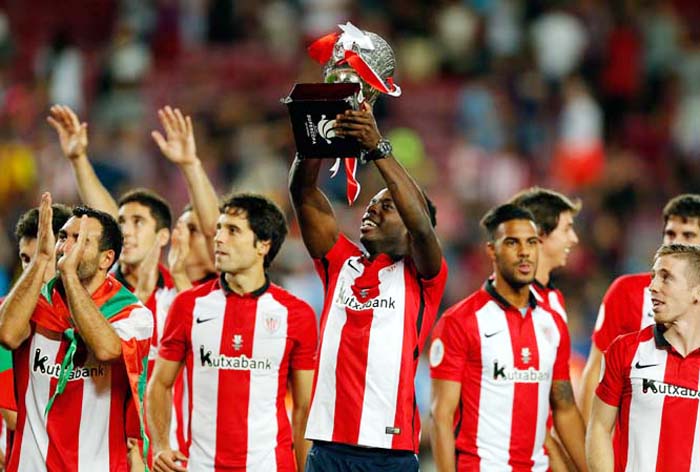 Athletic Bilbao's Inaki Williams lifts the trophy at the end of a second leg Spanish Super Cup soccer match between FC Barcelona and Athletic Bilbao at the Camp Nou stadium in Barcelona, Spain on Monday. After a 1-1 draw Athletic Bilbao won the trophy f