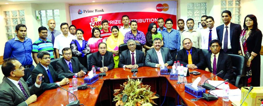 Ahmed Kamal Khan Chowdhury, Managing Director and Habibur Rahman, Deputy Managing Director of Prime Bank and Syed Mohammad Kamal, Country Manager MasterCard Bangladesh pose with the winners of 'Card-Start-Go!' campaign for its Debit cardholders recently