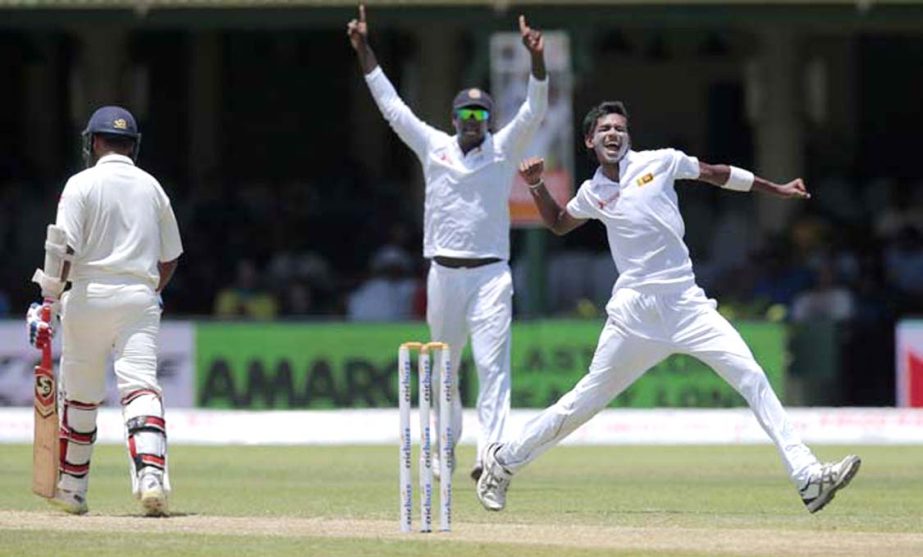 Sri Lanka's Dushmantha Chameera (right) celebrates the dismissal of India's Amit Mishra (left) during the second day's play of their second Test cricket match in Colombo, Sri Lanka on Friday.