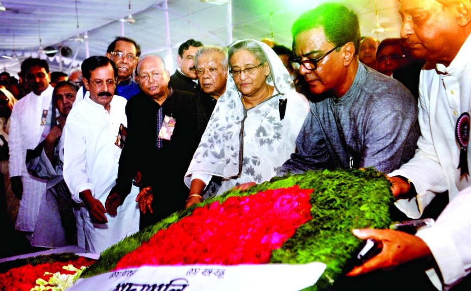 Prime Minister Sheikh Hasina along with party leaders pay respect to August 21 carnage victims by placing wreaths in front of Awami League Central office at Bangabandhu Avenue on Friday.