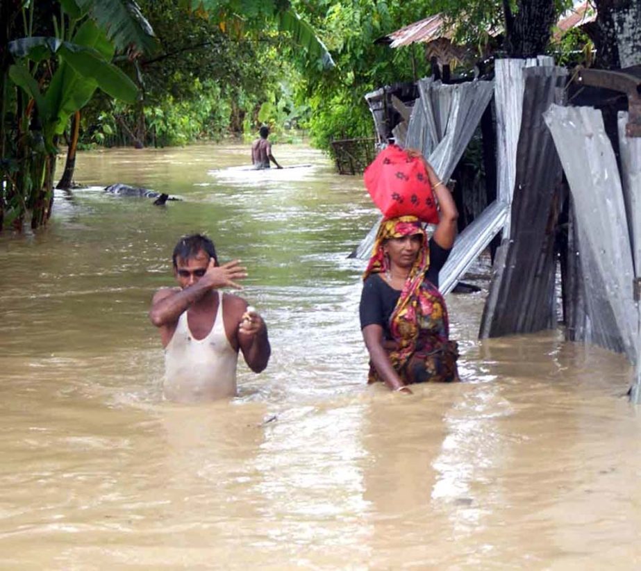 People in Gongopara area in Khagrachhori moving for a safe place as their houses are under flood water. This picture was taken on Friday.